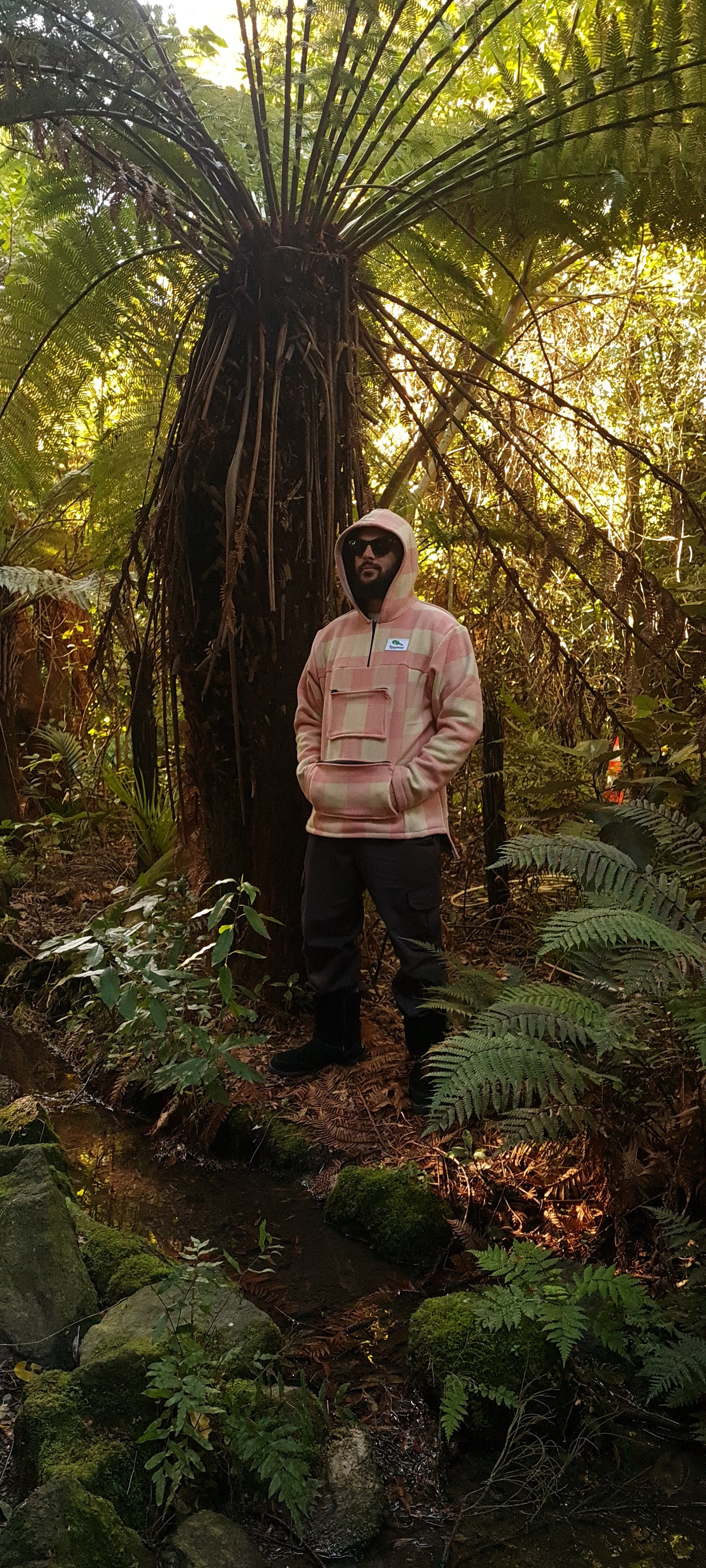 Make a statement in the Checked Pink/White Raumoa Wool Anorak Jacket, a luxurious NZ-made wool jacket that adds a touch of sophistication to your cold-weather ensemble. side picture with hood on.