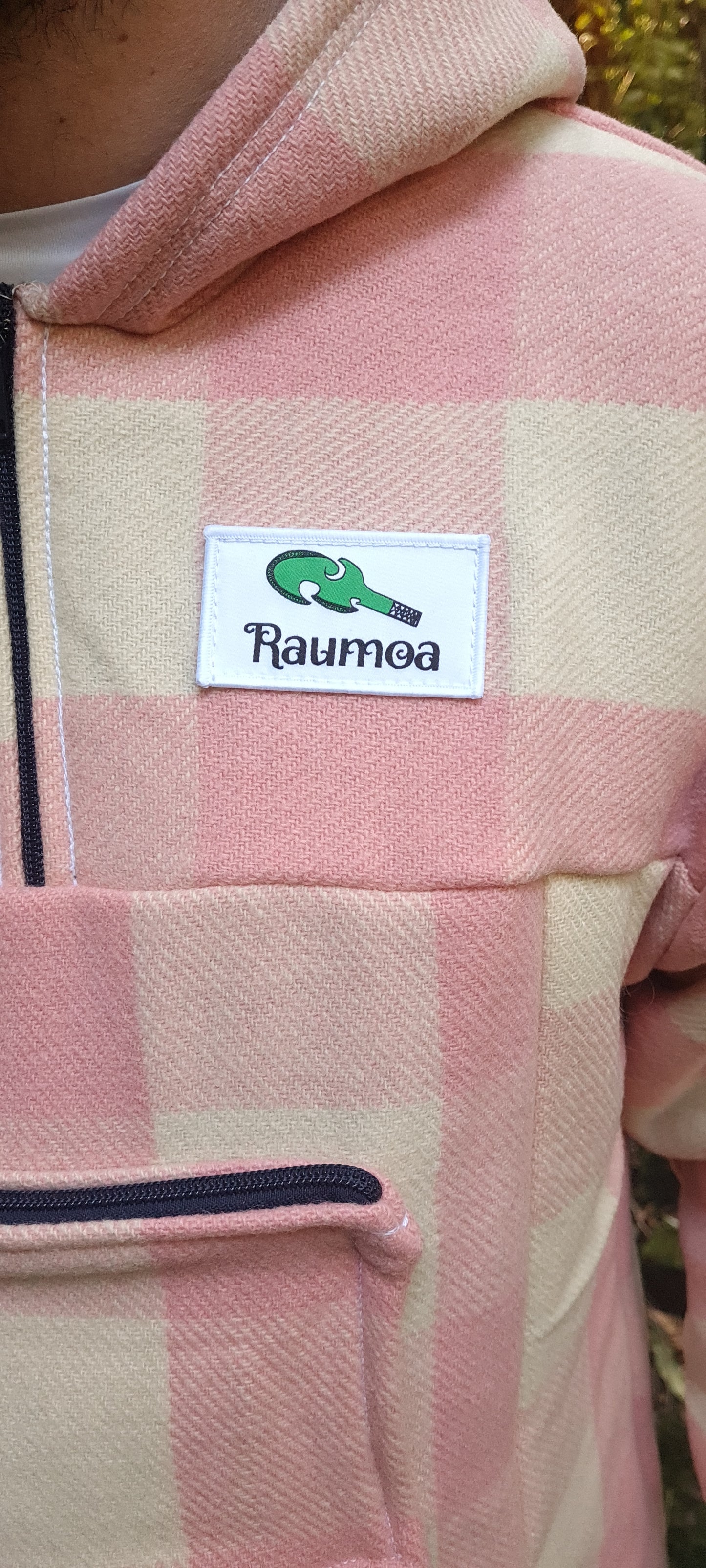 Celebrate New Zealand's fashion legacy with the Checked Pink/White Raumoa Wool Anorak Jacket, a finely tailored and NZ-made wool jacket that exudes elegance and quality. logo picture.