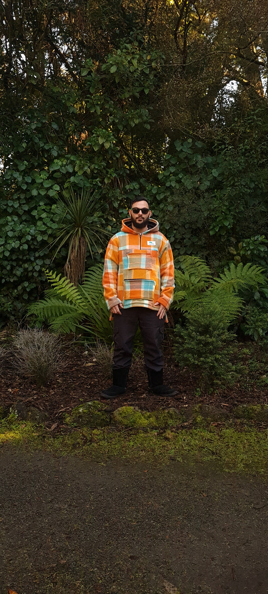 Experience the thrill of the wild with the Checked Orange/Blue Raumoa Wool Anorak Jacket, a stylish and adaptable garment crafted for both hiking and hunting expeditions. front picture.