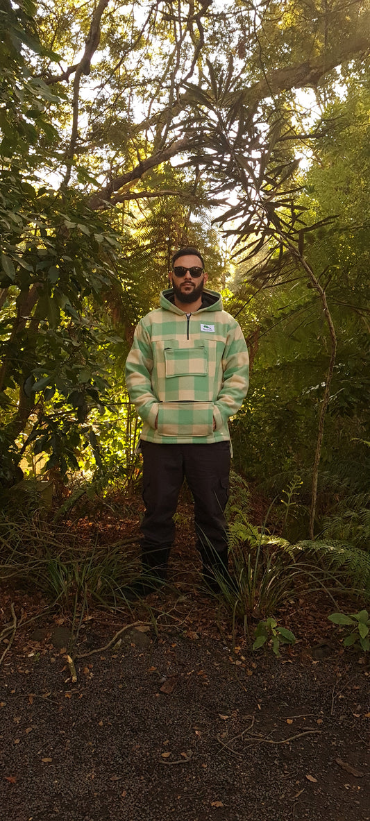 Discover the perfect blend of tradition and functionality in the Checked Green/White Raumoa Wool Anorak Jacket, a hunting jacket inspired by Maori clothing, ideal for outdoor enthusiasts. front picture.