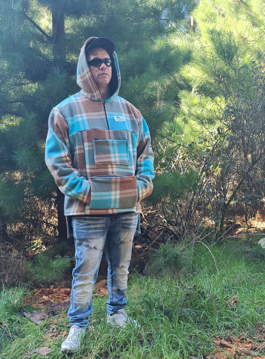 Radiate your outdoor pursuits with the Checked Blue/Brown Raumoa Wool Anorak Jacket, a unique blend of hunting & fishing functionality infused with the richness of Maori wear aesthetics. side picture.