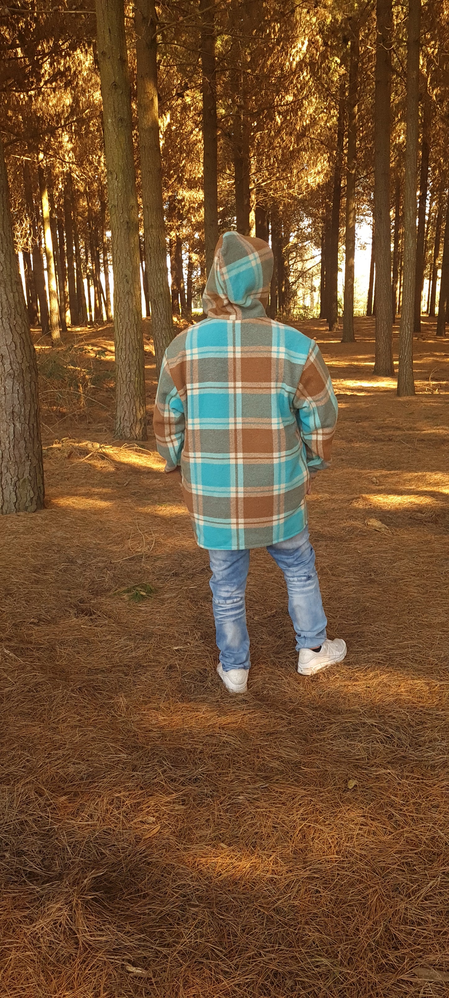 Immerse yourself in cultural outdoor fashion with the Checked Blue/Brown Raumoa Wool Anorak Jacket, a stylish and practical choice inspired by Maori wear, perfect for hunting & fishing adventures. back picture.