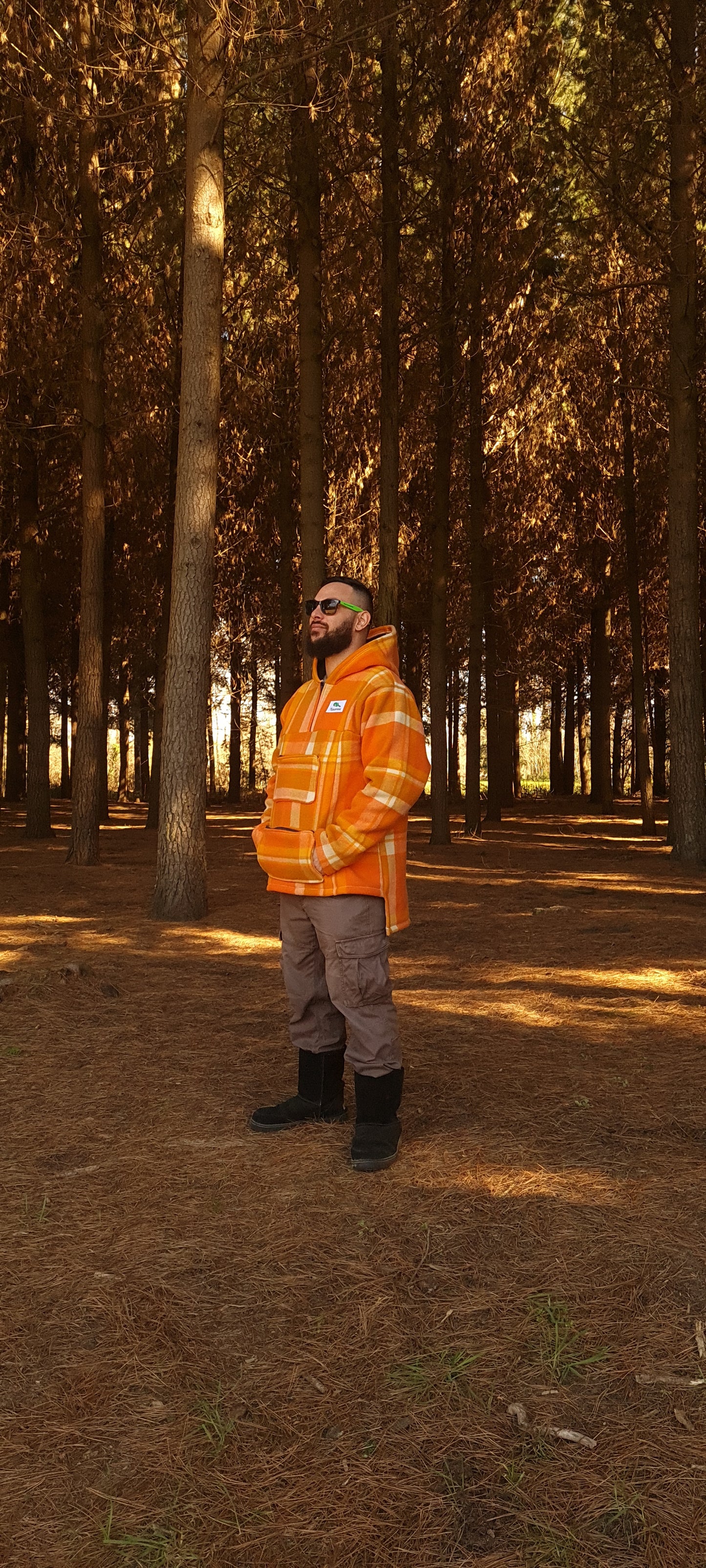   Experience the perfect blend of fashion and function with the checked orange Raumoa Wool Anorak Jacket, your ideal hunting jacket for the avid outdoorsman.  side picture.