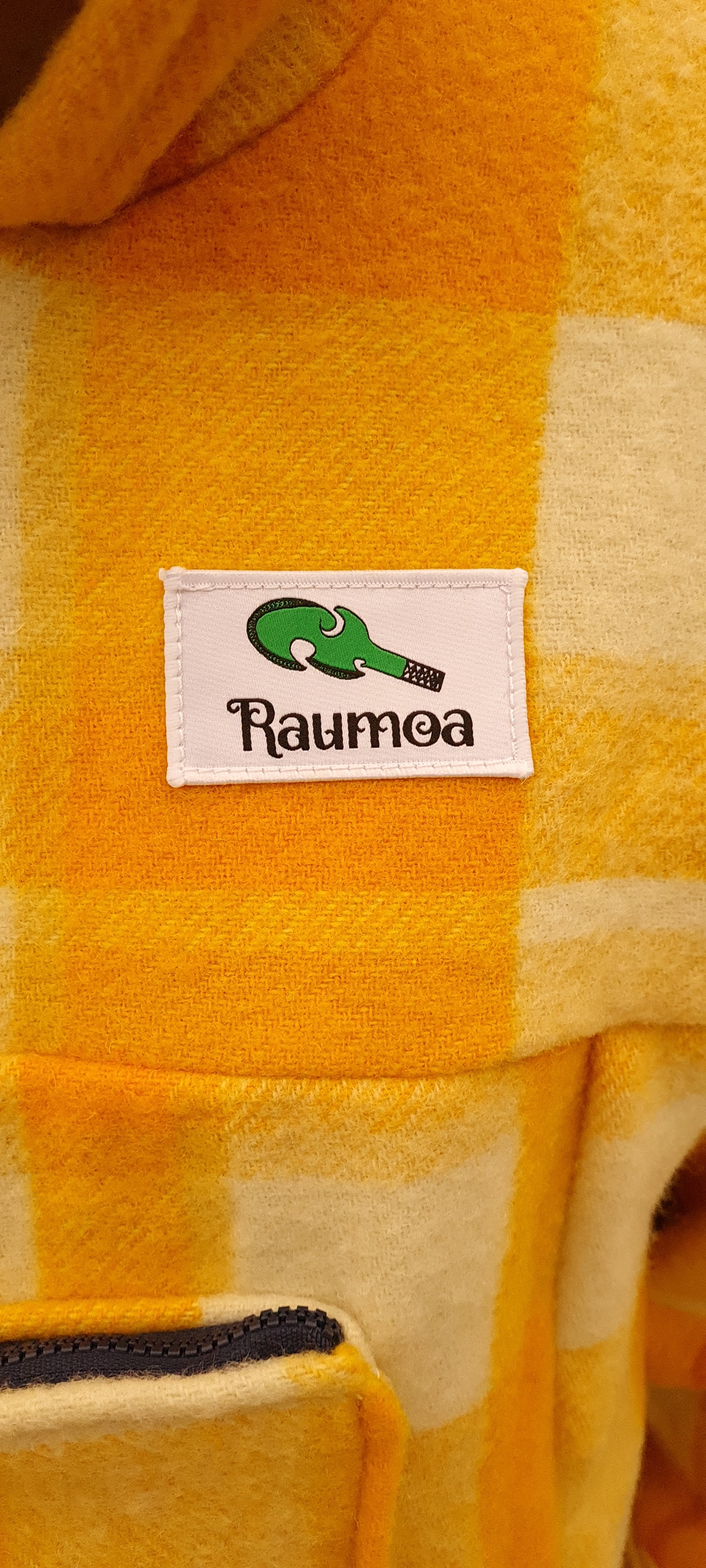 Make a bold statement in the wild with the Checked Yellow Raumoa Wool Anorak Jacket, a stylish and reliable bush jacket crafted for outdoor enthusiasts. logo picture