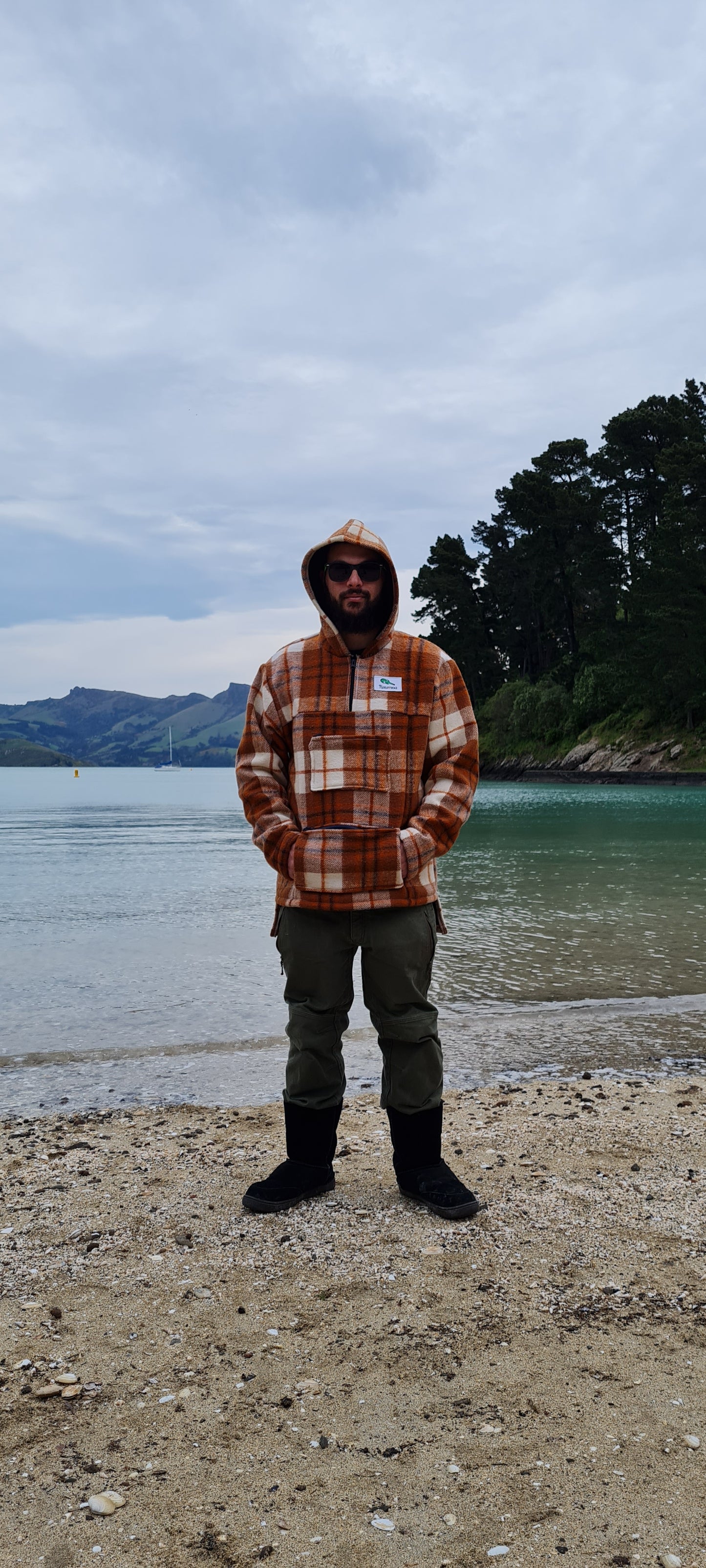 Celebrate heritage and style with the Checked Brown Raumoa Wool Anorak Jacket, a timeless wool coat inspired by Maori clothing traditions, perfect for a touch of cultural flair. front picture