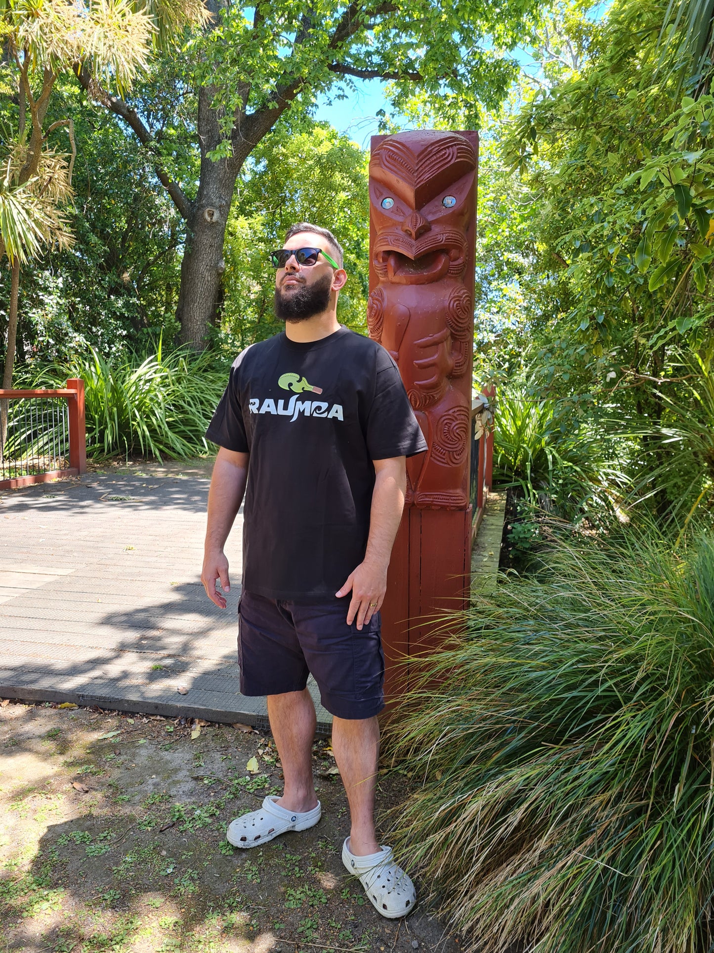 Unique Maori Streetwear black T-shirt showcasing contemporary Maori design clothing and cultural. This Maori apparel piece seamlessly blends tradition with modern style, making it a distinctive addition to your wardrobe. Elevate your streetwear with this culturally inspired fashion statement. [Image: side View of black t shirt.]