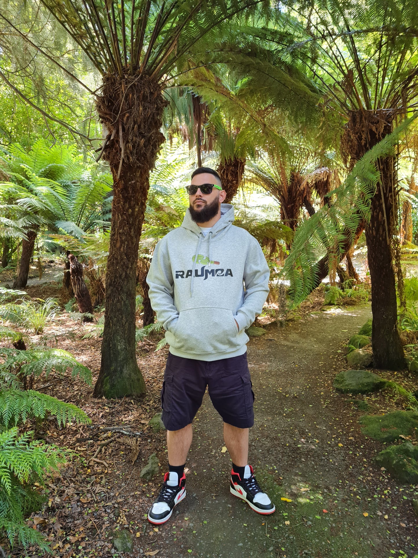 Elevate your style in our Māori- design grey hoodie from raumoa clothing. Discover the essence of Maori culture through unique maori design clothing and quality craftsmanship. Explore our collection of authentic Maori wear online.  [Image: front View of grey Hoodie.]