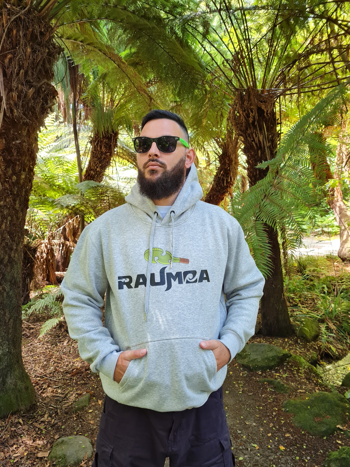 Maori designer grey hoodie with fleece inside, a masterpiece in Indigenous maori wear. Immerse yourself in the cultural richness and unique designs that define our collection of Maori designer clothing. Explore the intersection of style and tradition. Shop online for authentic Indigenous fashion